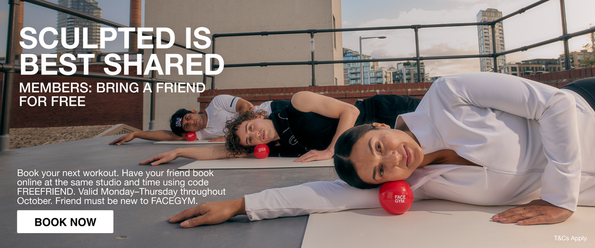 a group of people lying on mats with red balls